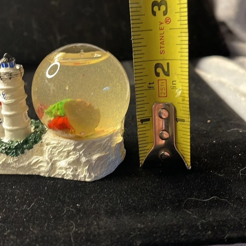 Small Snow Globe Lighthouse w/red roof house-color is clouded Santa is a floater